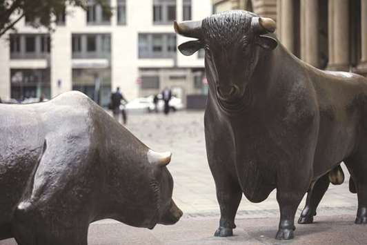 Bear and bull statues stand outside the Frankfurt Stock Exchange. The DAX 30 ended yesterday 0.1% up at 12,982.89 points.