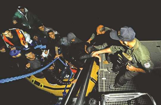 A group of Tunisians arrive yesterday on a rubber boat after being rescued by the Tunisian navy off the coast of Bizerte.