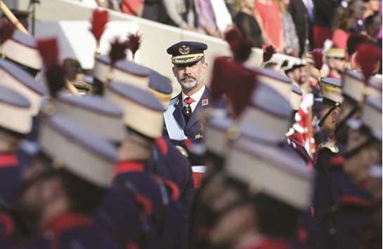 King Felipe reviews troops during the Spanish National Day military parade in Madrid.