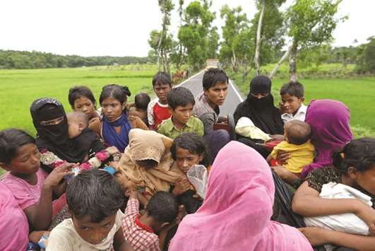 Rohingya refugees who crossed the border last night ride on the back of the truck that takes them to a camp near Teknaf, Bangladesh.