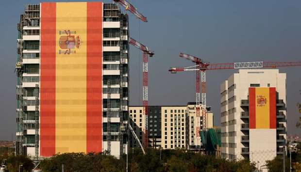 Buildings are draped in giant Spanish flags in a suburb of Madrid
