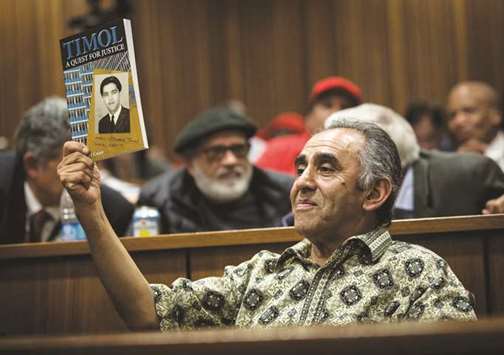 Mohamed Timol, brother of late Ahmed Timol, holds up a copy of the book Timol u2013 A quest for justice at the judgment proceedings at the Pretoria High Court.