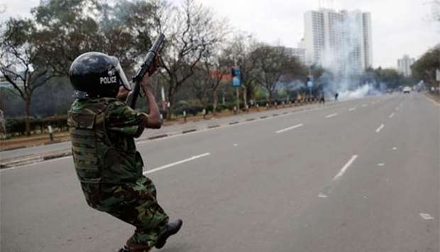 A riot policeman fires tear gas to disperse opposition supporters during a protest in Nairobi on Friday.