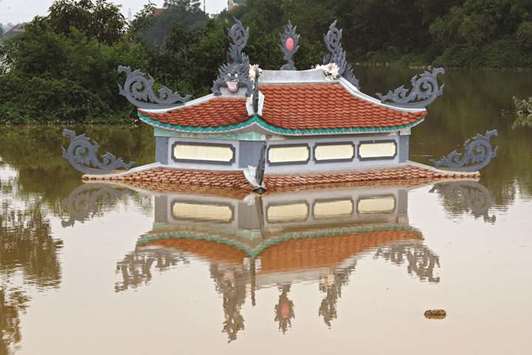 A submerged temple is seen in a flooded village after a tropical depression in Hanoi, Vietnam.