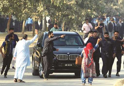 Maryam Nawaz, daughter of ousted premier Nawaz Sharif, waves from the vehicle as she arrives at an accountability court in Islamabad yesterday.