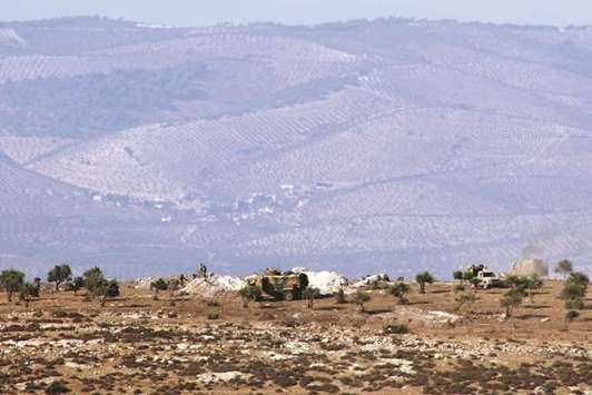 A picture taken yesterday, shows Turkish forces positioned on a hill in the Syrian border town of Salwah.