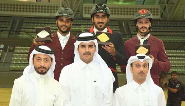 Riders of the u2018Open Classu2019 pose on the podium with their medals with Al Shaqabu2019s Commercial Manager Omar al-Mannai (right), Hayen al-Hajri, Protocol Specialist of Al Shaqab and Nasser al-Hajri, Showjumping Grand Jury President, yesterday.