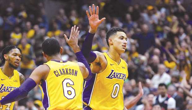 Kyle Kuzma (No 0) of the Los Angeles Lakers celebrates with his teammate Jordan Clarkson during the game against the Minnesota Timberwolves on September 30 at the Honda Centre in Anaheim, California. (AFP/Getty Images)