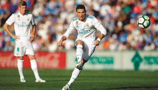 Real Madridu2019s Cristiano Ronaldo kicks the ball during the La Liga match against Getafe yesterday. (AFP)