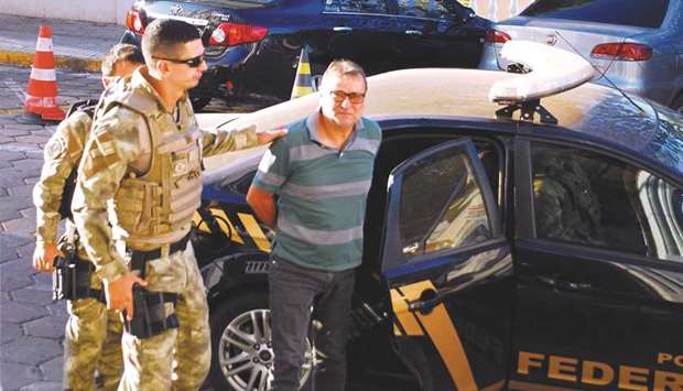 This picture taken on October 5 shows Battisti being escorted by police to the headquarters of the Federal Police in Corumba, Mato Grosso do Sul State, Brazil.