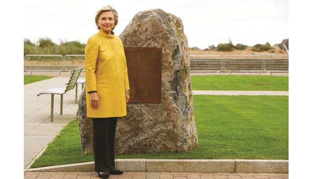 Clinton stands by a commemorative stone at the Swansea University Bay Campus, where she received an honorary doctorate at a ceremony yesterday, in Swansea, south Wales. The award is being made by the university in recognition of her commitment to promoting the rights of families and children around the world, the university said in a statement.