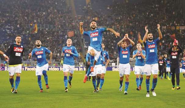 Napoli players celebrate after their win over Roma in the Serie A at Stadio Olimpico in Rome on Saturday night. (Reuters)