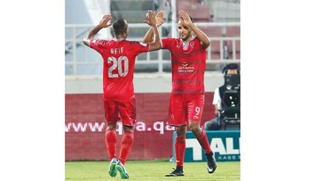 Yousef El Arabi (R) celebrating one of his four goals against Al Ahli yesterday.