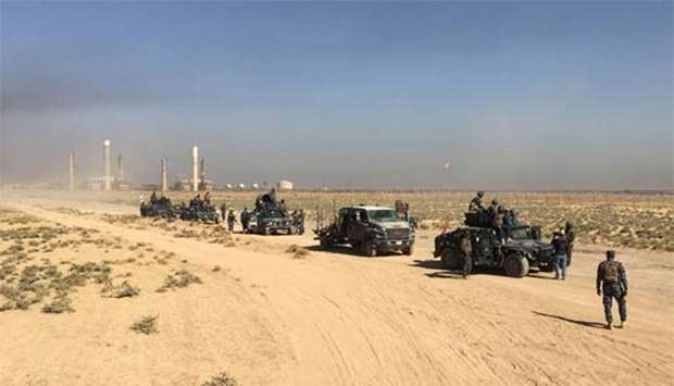Members of Iraqi federal forces enter oil fields in Kirkuk on Monday.