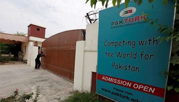 A man closes the main gate of PakTurk International Schools and Colleges in Islamabad in this file photo.