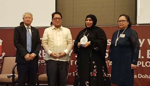 Dr Hanadi al-Hamad receives her award from labour secretary Silvestre Bello III and Philippine ambassador Alan Timbayan. PICTURE: Joey Aguilar