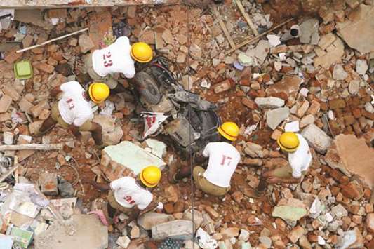 Personnel from the fire brigade and National Disaster Response Force clear debris during rescue efforts after a two-storey residential building collapsed in Ejipura in Bengaluru yesterday.