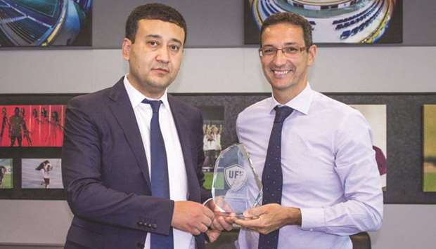 Director General of Aspire Academy Ivan Bravo (right) presents a shield to Umid Ahmadjonov, the President of Uzbekistan Football Federation, yesterday.