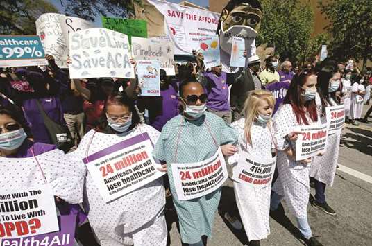 Thousands of healthcare industry workers and union members march down Temple Street in downtown Los Angeles in support of the Affordable Care Act, in a March 23, 2017, file image.