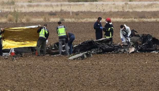 Rescue workers are seen at the crash site of a military F18 fighter plane which crashed at Torrejon airbase in Torrejon de Ardoz, outside Madrid, Spain
