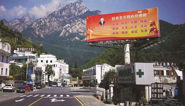 A poster with a portrait of Chinese President Xi Jinping overlooks a street in Huangshan, Anhui province, China. The slogan reads: u201cCore Socialist Values: prosperity, democracy, civility, and harmony; freedom, equality, justice, rule of law; patriotism, dedication, integrity and friendship.u201d