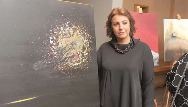 THE PAINTER: Cristina Albaker with one of her works.