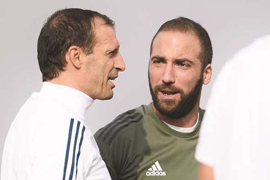 Juventusu2019 coach Massimiliano Allegri (left) and Gonzalo Higuain attend a training session in Turin. (AFP)