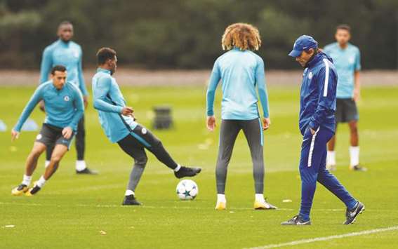 Chelsea manager Antonio Conte is in deep thought as his players take part in training session at the Cobham Training Centre in London yesterday. (Reuters)