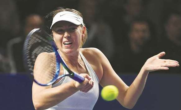 Russiau2019s Maria Sharapova returns the ball to Slovakiau2019s Magdalena Rybarikova during their first round match at the Kremlin Cup in Moscow yesterday. (AFP)