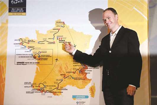 Tour de France 2017 winner Chris Froome of Britain poses with map of the itinerary of the 2018 Tour de France race in Paris yesterday. (Reuters)