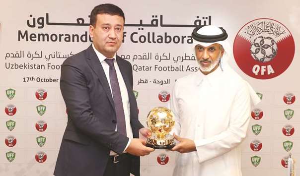Qatar Football Association (QFA) president Sheikh Hamad bin Khalifa bin Ahmed al-Thani (right) and Uzbekistan Football Federation president Umid Ahmadjonov at the QFA headquarters in Doha yesterday.