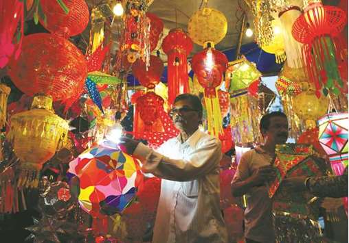 Vendors show lanterns to customers at a roadside market ahead of Diwali in Mumbai yesterday.