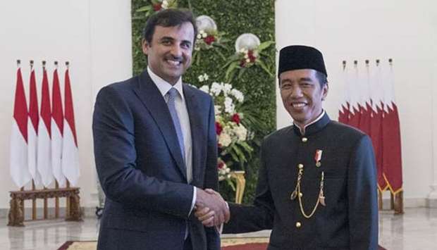 His Highness the Emir Sheikh Tamim bin Hamad al-Thani shakes hands with Indonesian President Joko Widodo in Jakarta on Wednesday.