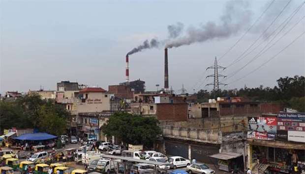 Smoke billows from two smoke stacks at the coal-based Badarpur Thermal Station in New Delhi in this file picture.