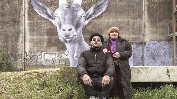 IN PROTEST: Both actor travellers u2014Agnu00e8s Varda, right u2014 erect the goat portrait on the side of a barn in protest of common local practice of dehorning.