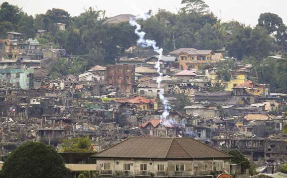 Teargas is fired by government troops as they continue their assault against the pro-Islamic State militant group during a clearing operation in Marawi city, southern Philippines, yesterday.