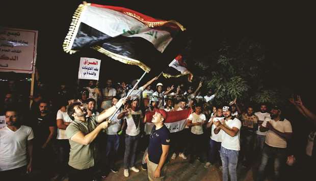 Iraqi people celebrate after Kirkuk was seized by the forces as they gather on the street of Baghdad, yesterday.