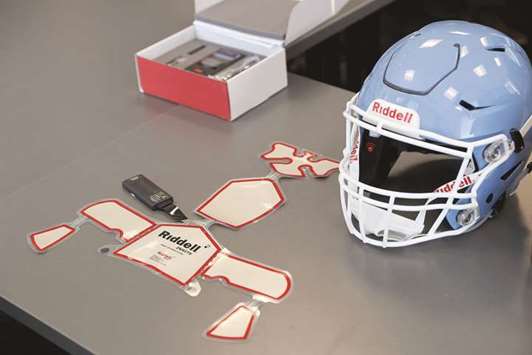 GETTING THE ACT TOGETHER: The Riddell impact response system which includes the alert monitor, in box above, and sensor pads used in the Riddell Speedflex Precision fit helmets at the Riddell headquarters.