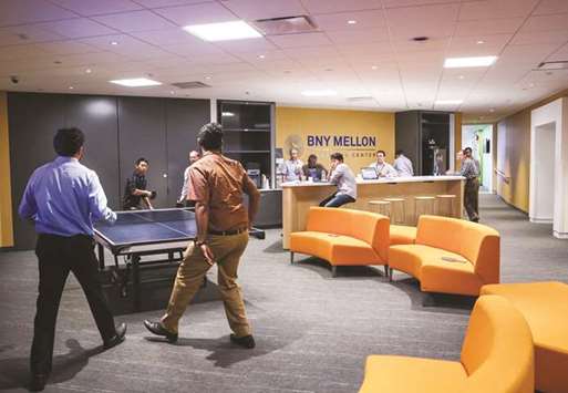 Employees play table tennis in the break area at the Bank of New York Mellon Corpu2019s innovation space in Jersey City, New Jersey, US. Within the upper echelons of many financial firms, thereu2019s a lot of soul searching as executives prepare to roll out a new generation of technology.