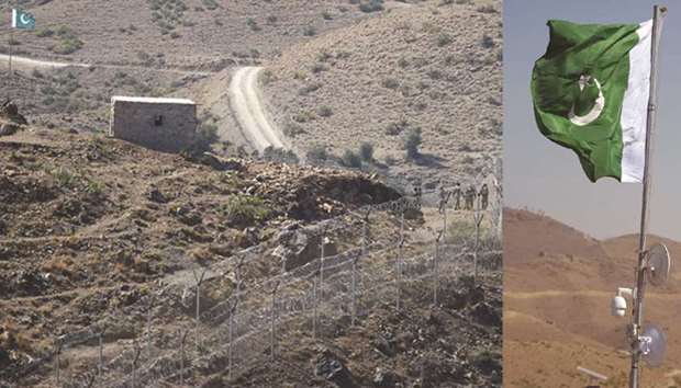 Pakistani soldiers (right) patrol next to a newly fenced border fencing along Afghan border at Kitton Orchard Post in Pakistanu2019s North Waziristan tribal agency on October 18, 2017. RIGHT: Pakistani national flag waves with electronic surveillance equipment near a newly fenced border fencing along Afghan border at Kitton Orchard Post.