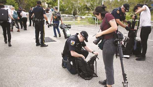 Police officers check the bags of journalists entering the site of a planned speech by white nationalist Richard Spencer at the University of Florida campus.