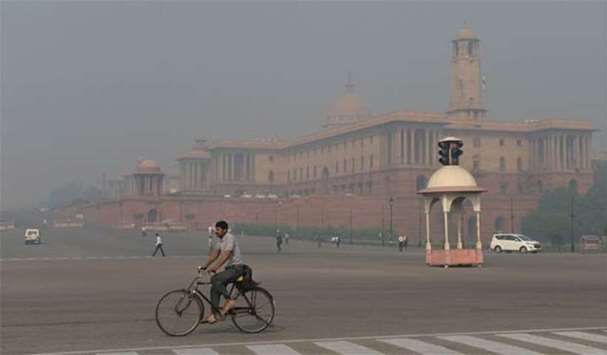 A cyclist riding on a street in central Delhi as the city was shrouded in thick smog
