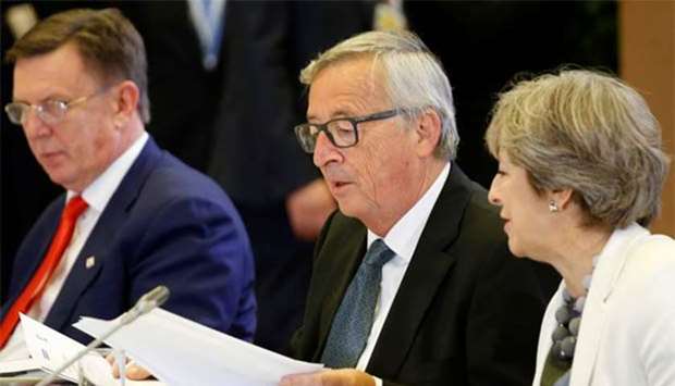 European Commission President Jean-Claude Juncker and British Prime Minister Theresa May take part in an EU summit in Brussels on Friday.
