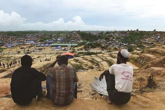 Rohingya refugee men overlook the Thaingkhali refugee camp in Ukhia town of Bangladesh.