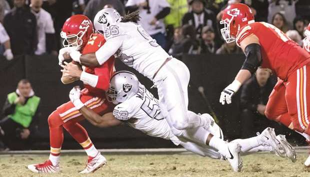 Oakland Raiders' Khalil Mack and Denico Autry combine to sack Kansas City Chiefs quarterback Alex Smith (left) during the NHL game at Oakland Coliseum. (USA TODAY Sports)