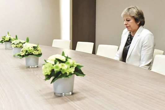 Prime Minister Theresa May takes a seat as she arrives for a bilateral meeting with European Council President Donald Tusk during an EU summit in Brussels yesterday.