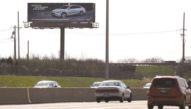 An interactive billboard on Interstate 88 near Eola Road in Aurora, Ill., touts the Chevy Malibu. The sign uses vehicle recognition technology to identify competing sedans and display ads aimed at their drivers.