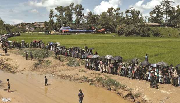 Rohingya refugees queue for aid in Coxu2019s Bazar yesterday.