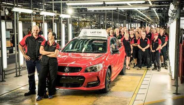 Workers of the Australian auto-maker Holden are seen with the last car to roll off its production line at Elizabeth in Adelaide on Friday.