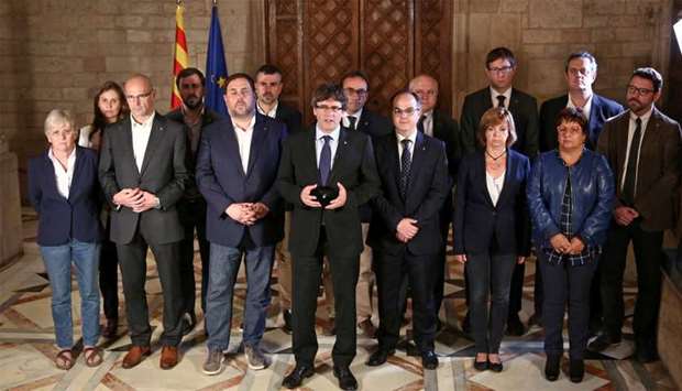 Catalan Regional President Puigdemont is flanked by members of his government
